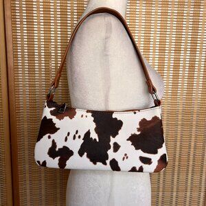 Y2K baguette shoulder bag featuring a bold brown and white cow print